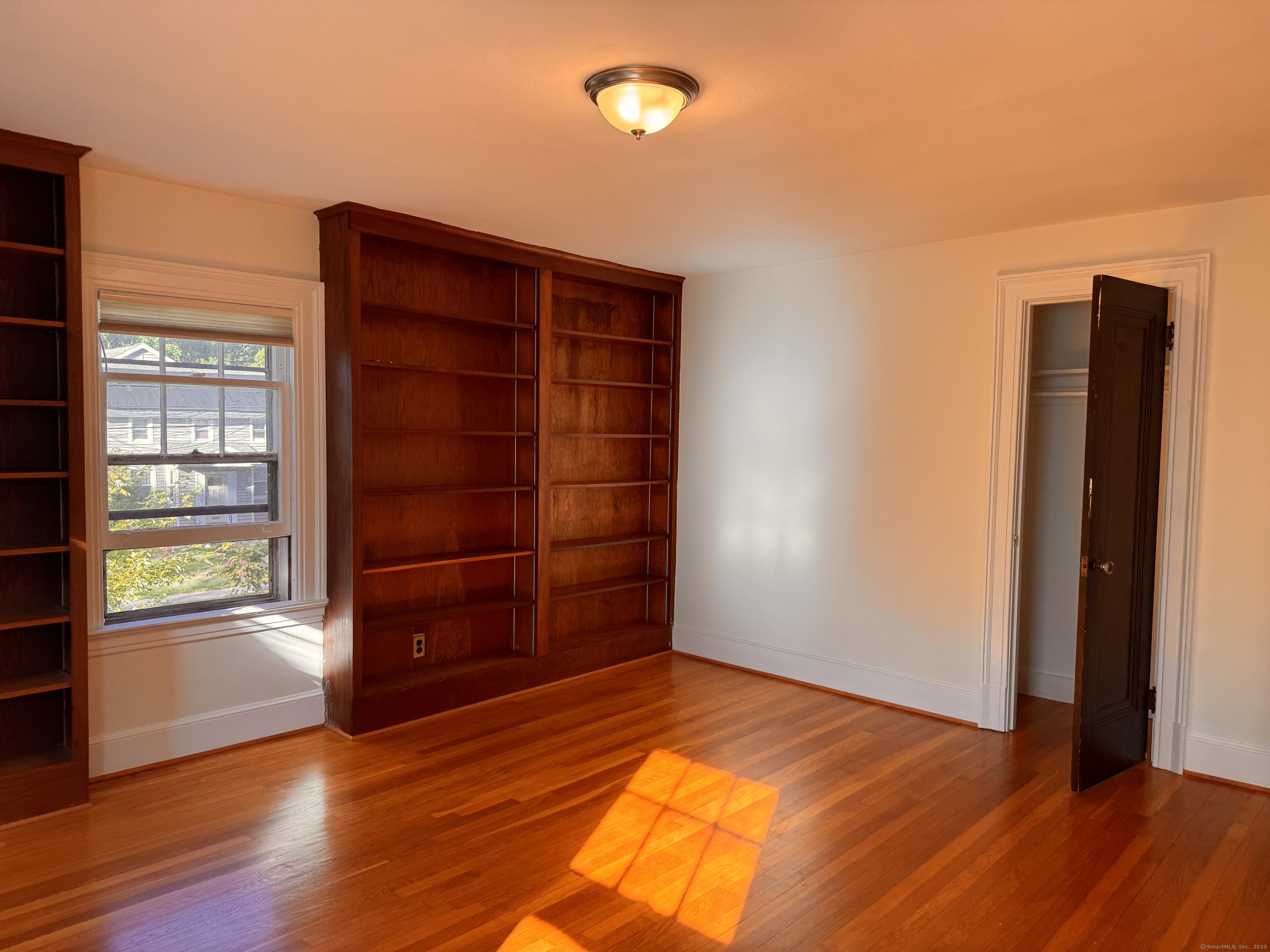 65 Spring Garden Street Hamden, CT 06517 - Photo 13 of 19 an empty room with wooden floor and closet