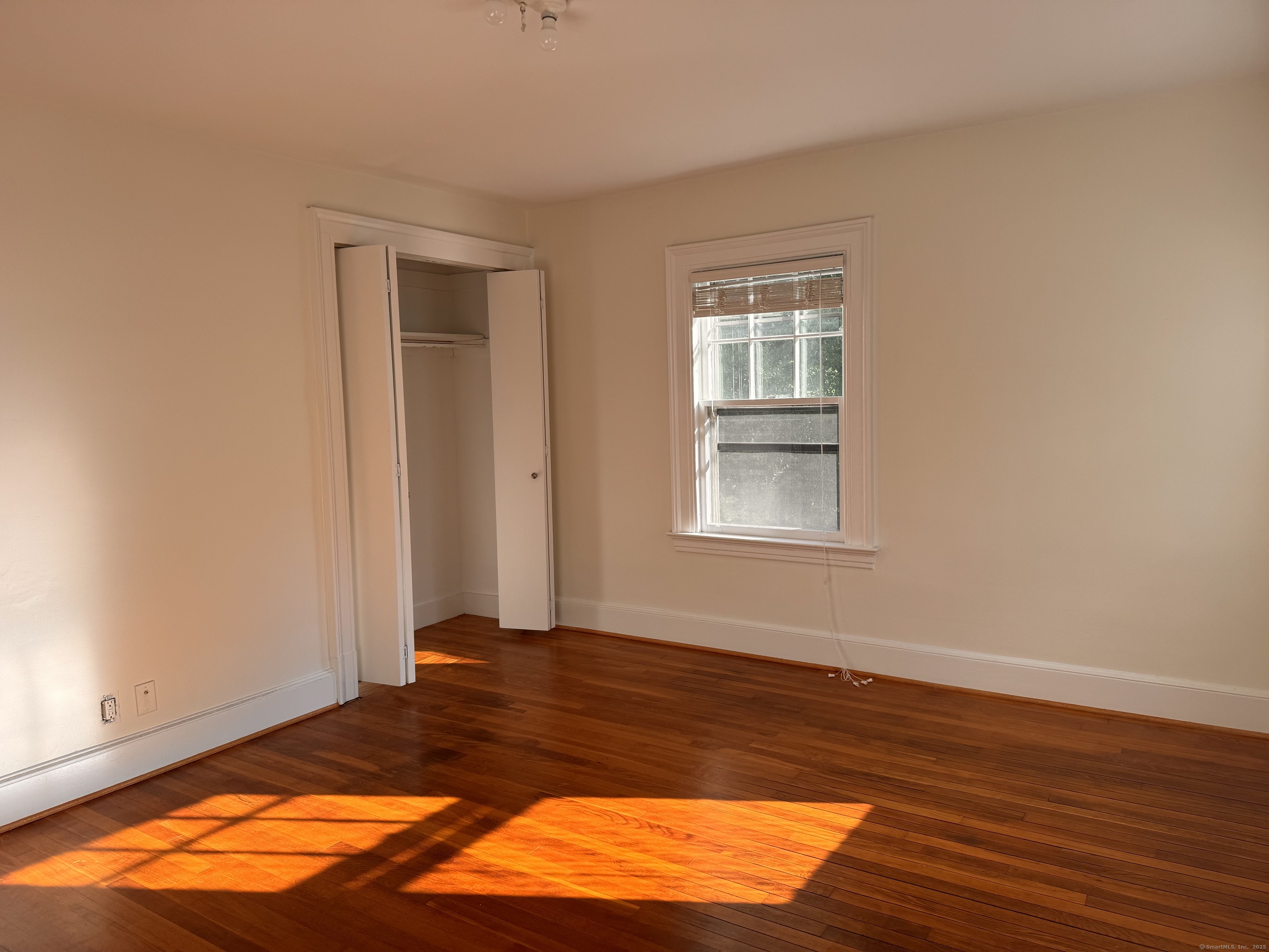 65 Spring Garden Street Hamden, CT 06517 - Photo 15 of 19 a view of a room with wooden floor and a window