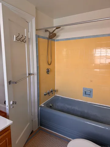 a bedroom with a couch and a dresser