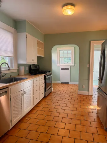 a kitchen with stainless steel appliances granite countertop a sink and cabinets