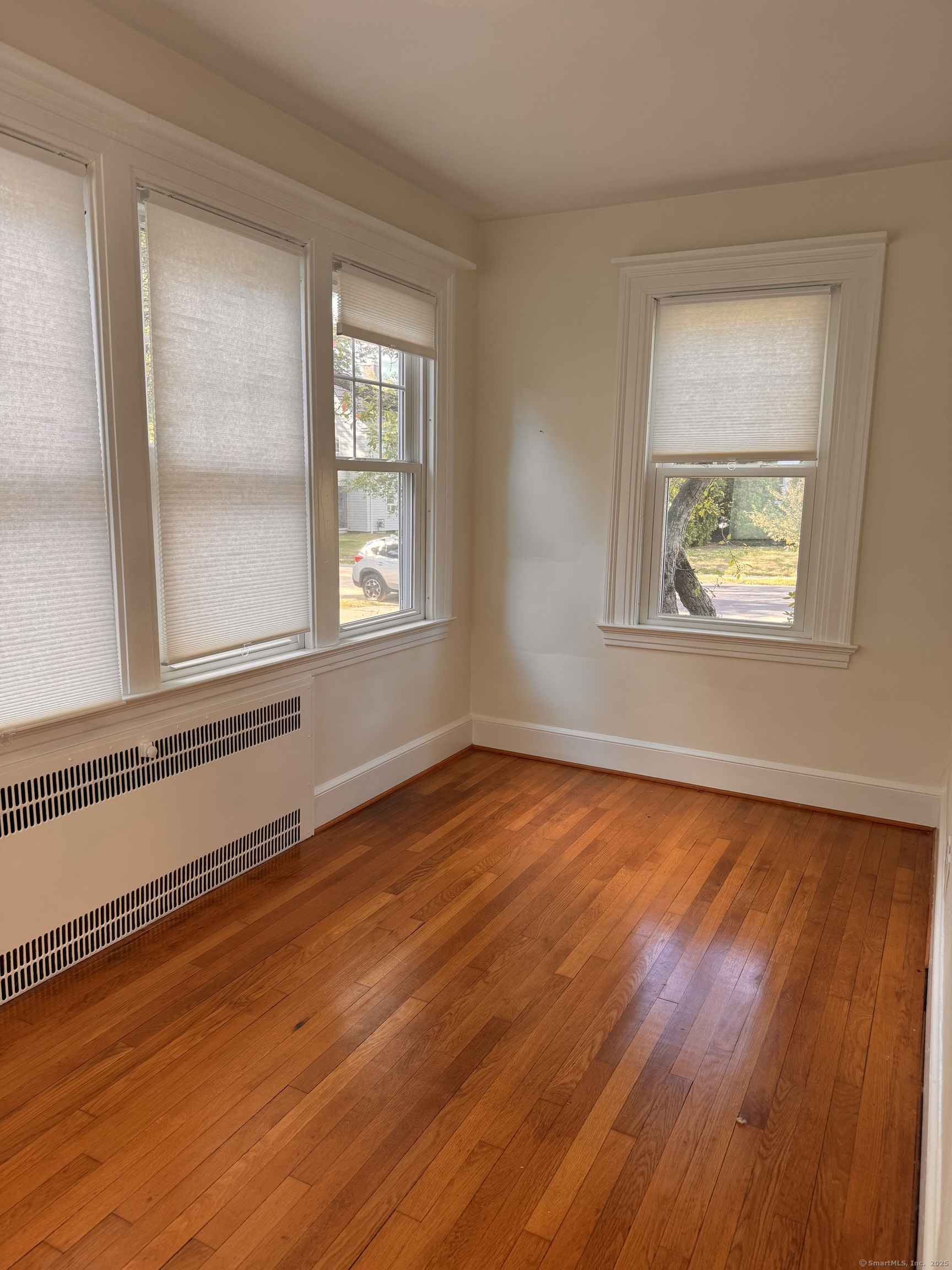 65 Spring Garden Street Hamden, CT 06517 - Photo 5 of 19 a view of an empty room with wooden floor and a window