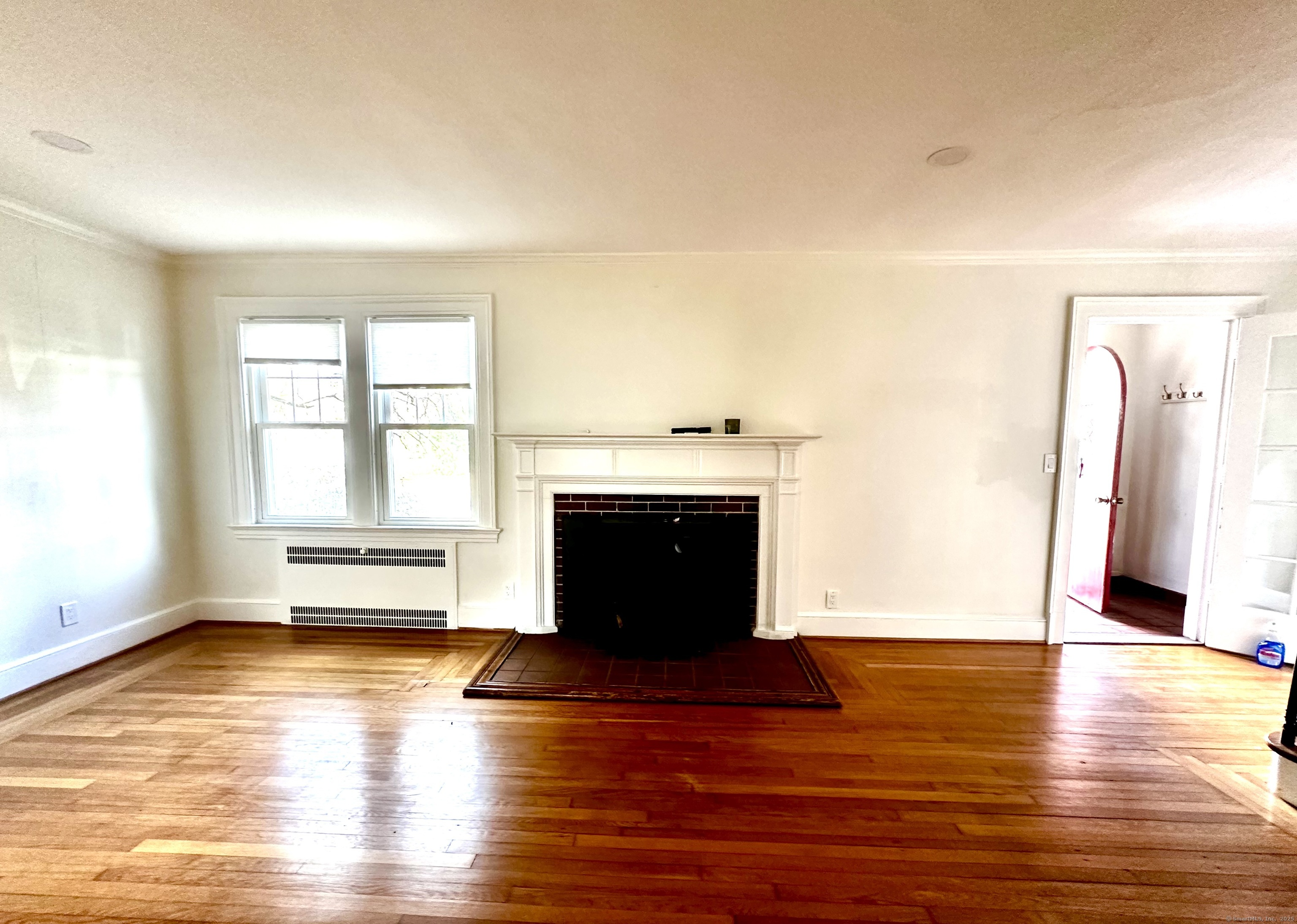 65 Spring Garden Street Hamden, CT 06517 - Photo 8 of 19 a view of empty room with wooden floor and fireplace