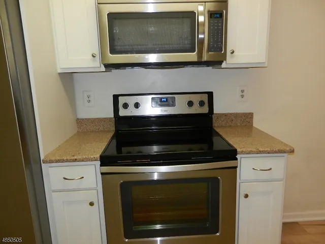 a stove top oven sitting inside of a kitchen