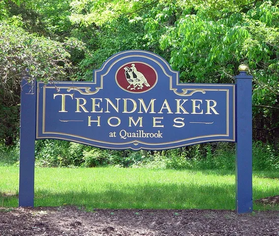 a sign broad in front of a tree