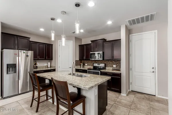 a kitchen with refrigerator and cabinets