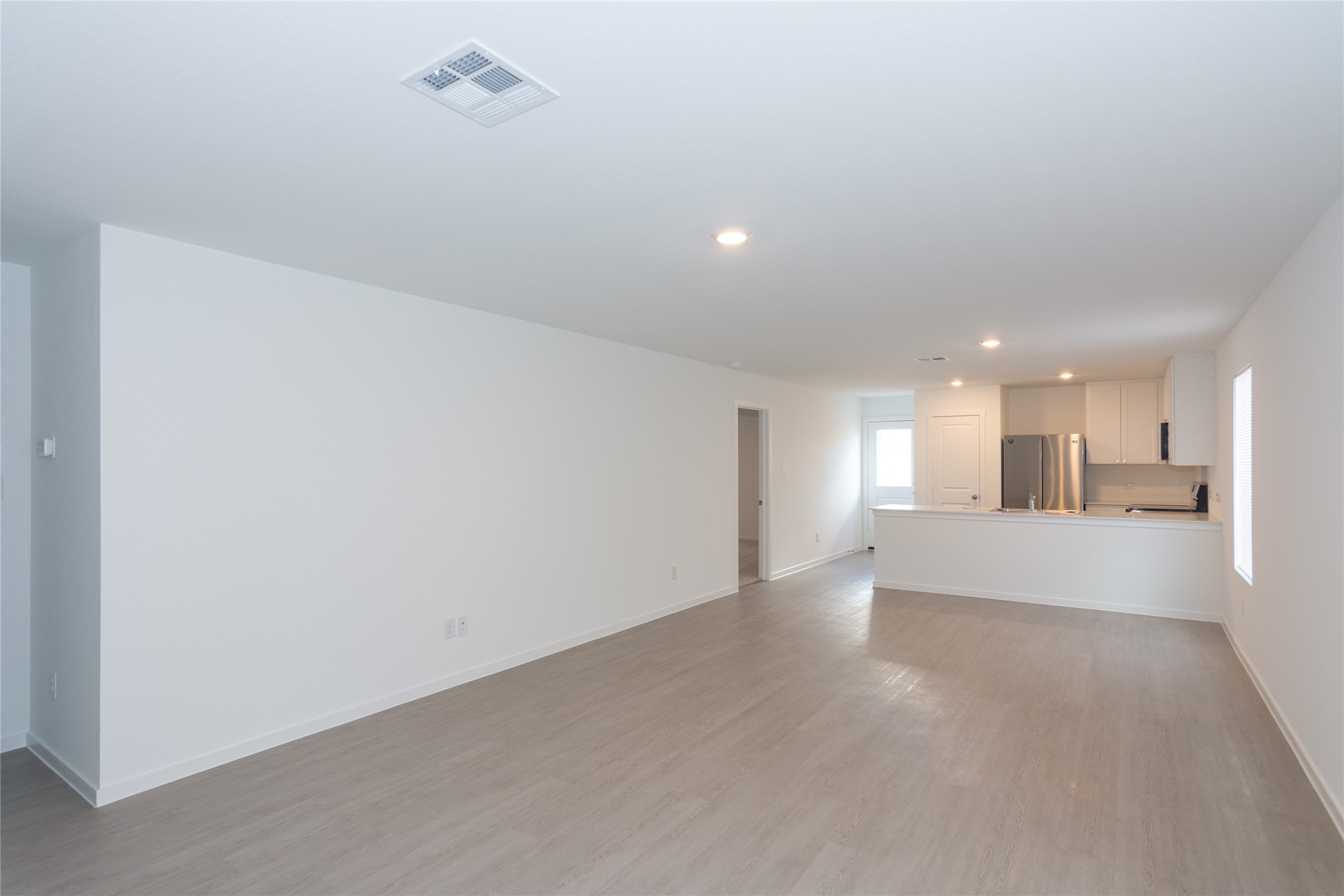 153 Star Packer Lane Jarrell, TX 76537 - Photo 29 of 30 An open floor plan with recessed lighting seamlessly integrates the living area and kitchen.