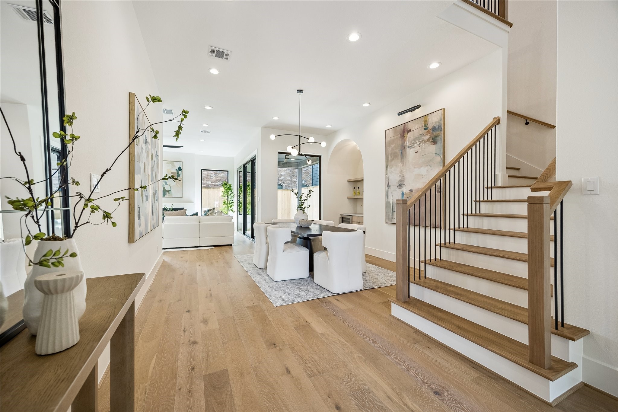 335 Harvard Street Houston, TX 77007 - Photo 5 of 35 Wood railing with iron balusters and wide plank wood flooring and designer lighting.