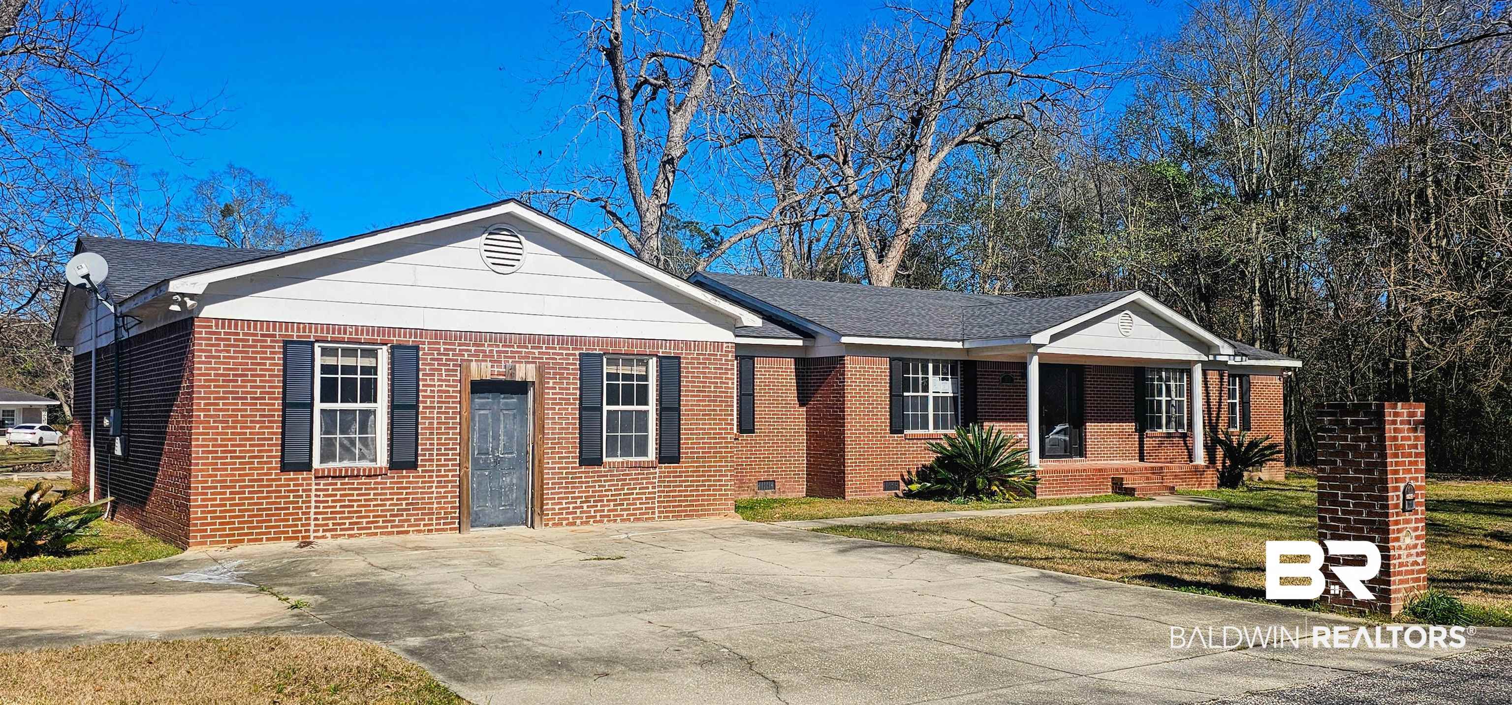 151 Bullard Street Atmore, AL 36502 - Photo 3 of 38 Ranch-style house featuring a front yard, crawl space, driveway, brick siding, and roof with shingles