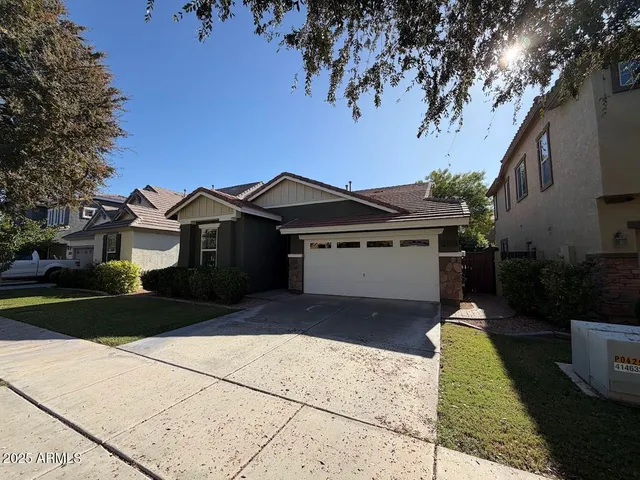 a front view of a house with a yard and trees