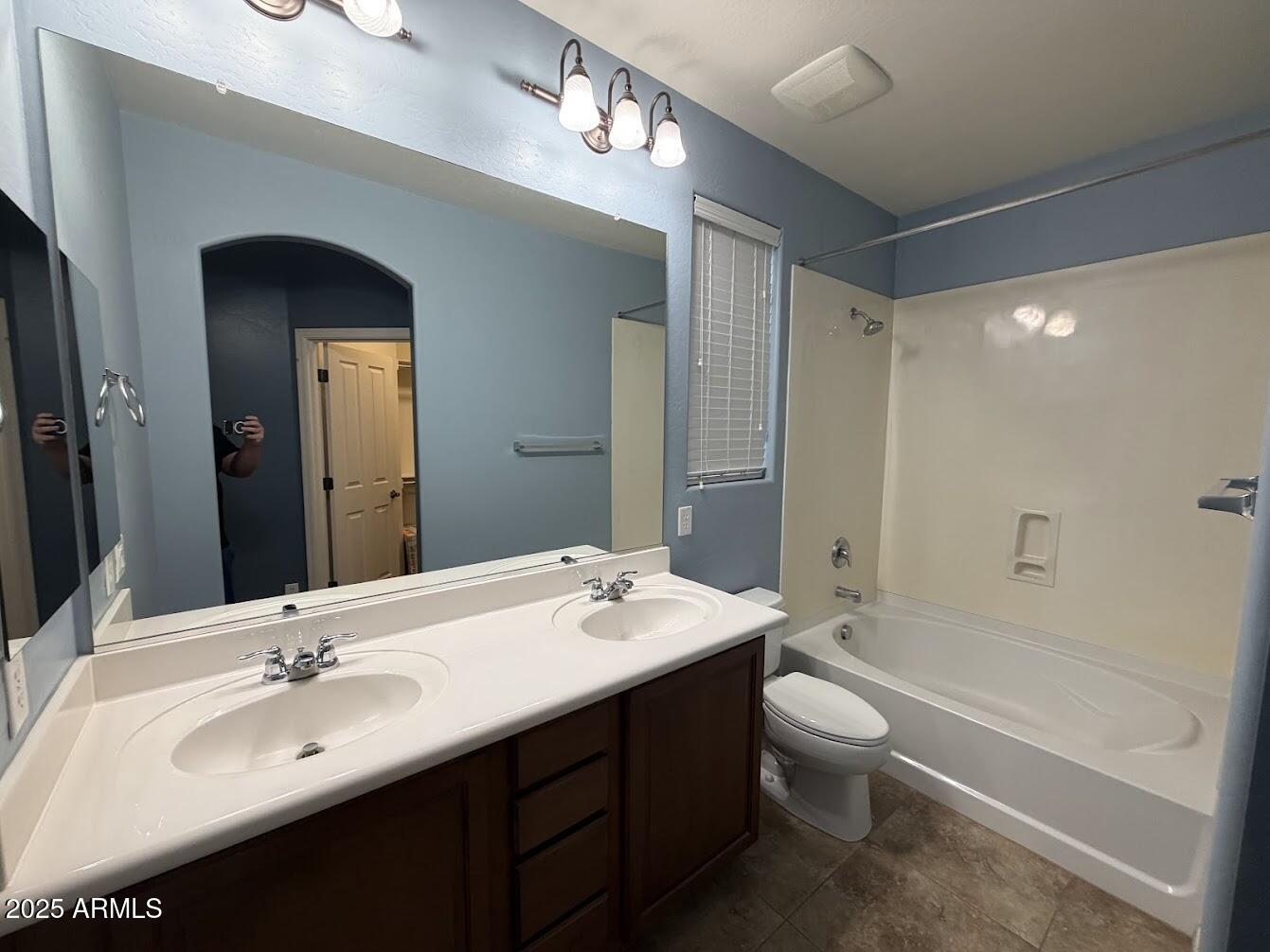 3349 East Cheyenne Street Gilbert, AZ 85296 - Photo 15 of 18 a bathroom with a double vanity sink toilet mirror and bathtub