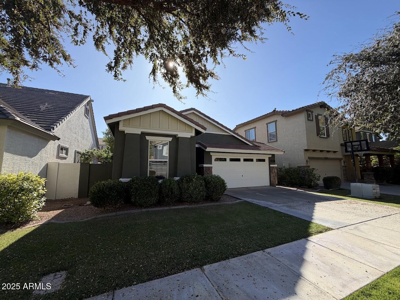 3349 East Cheyenne Street Gilbert, AZ 85296 - Photo 2 of 18 a front view of a house with a garden and yard
