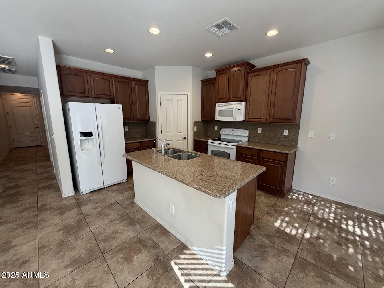 3349 East Cheyenne Street Gilbert, AZ 85296 - Photo 3 of 18 a kitchen with stainless steel appliances granite countertop a refrigerator stove a sink and a oven