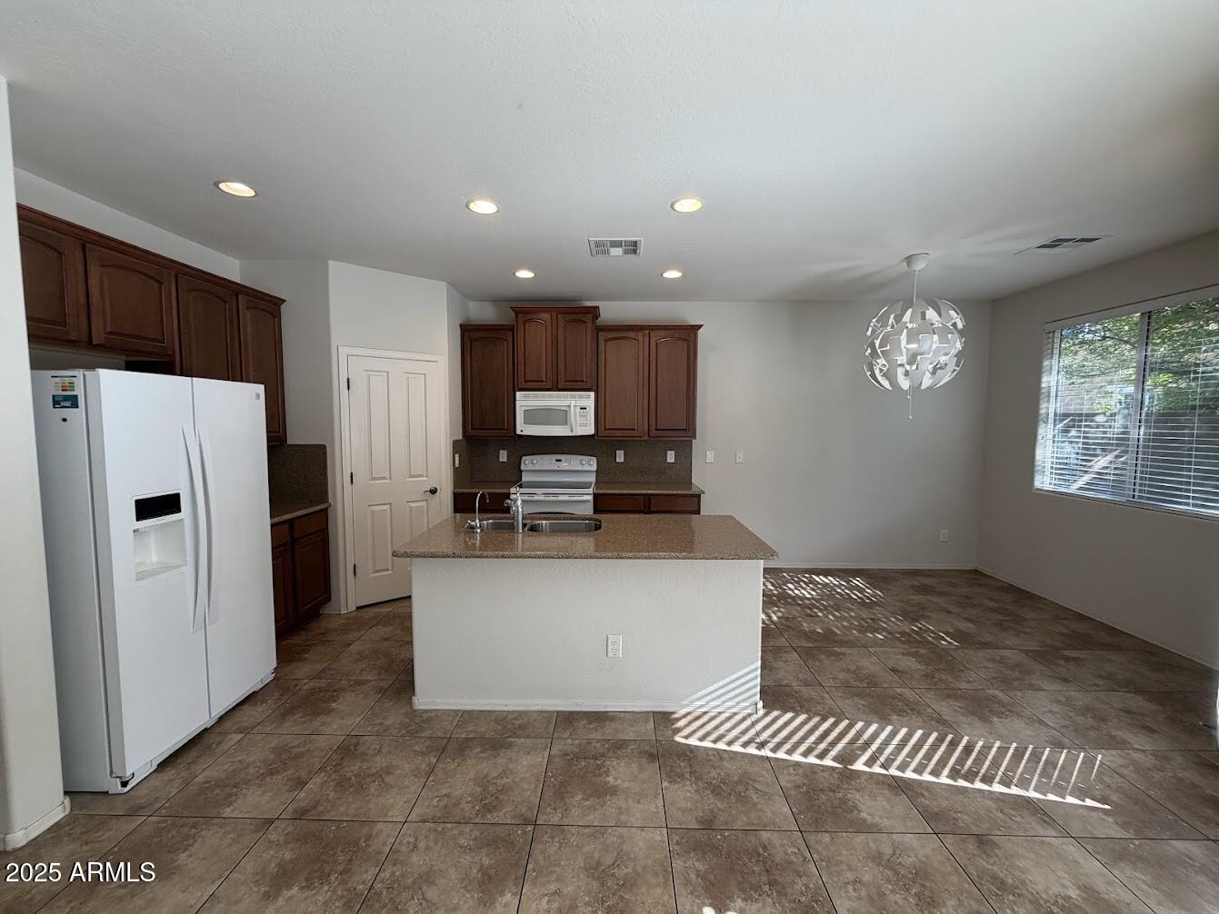 3349 East Cheyenne Street Gilbert, AZ 85296 - Photo 4 of 18 a view of kitchen with refrigerator stove microwave and cabinets