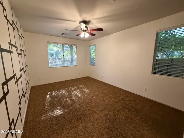 a view of an empty room with windows
