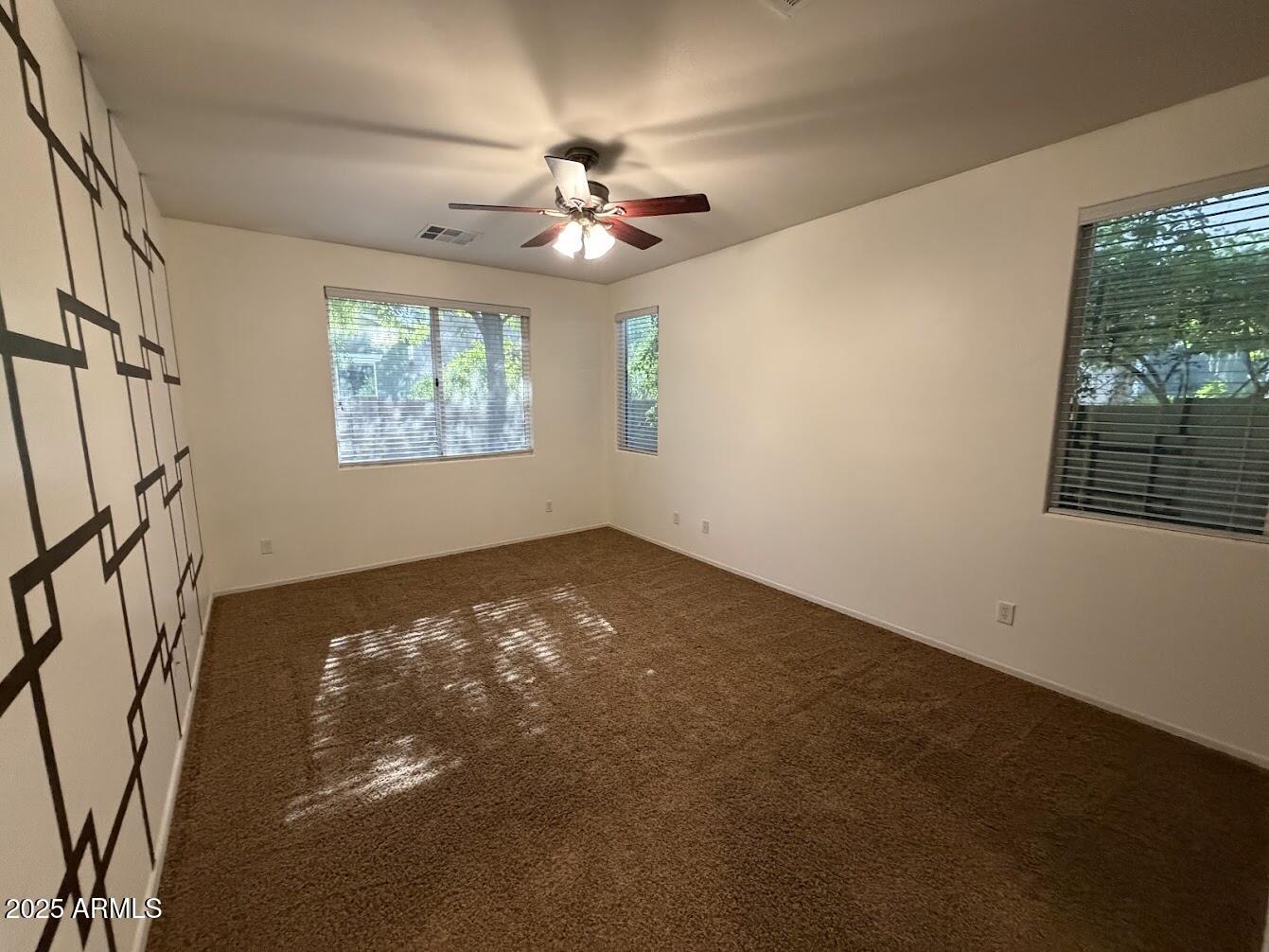 3349 East Cheyenne Street Gilbert, AZ 85296 - Photo 9 of 18 a view of an empty room with windows