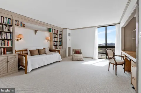a bedroom with furniture and a window