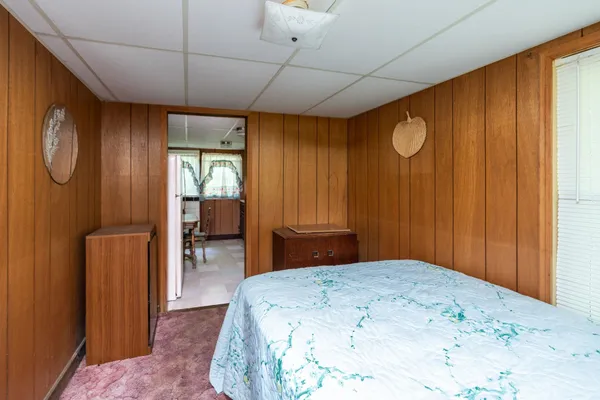 a bedroom with a bed and a dresser