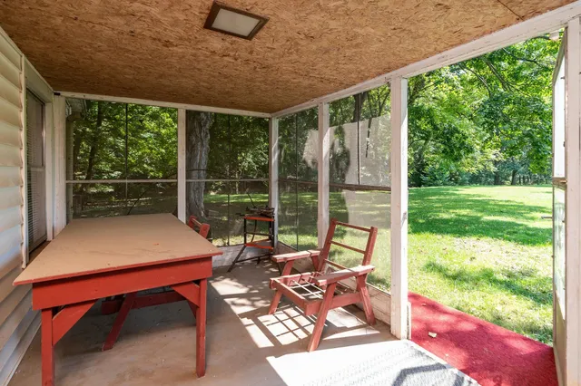 a view of a patio with a yard table and chairs