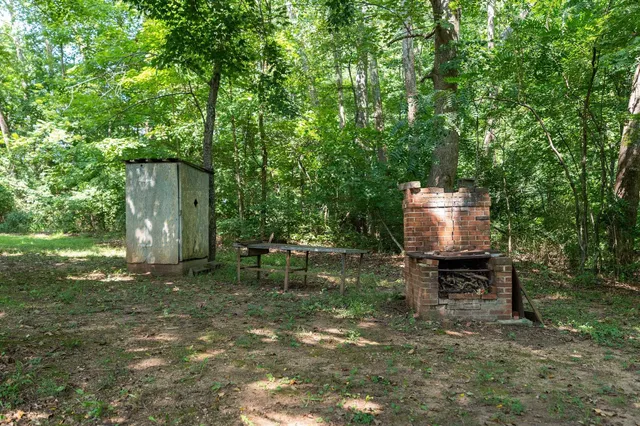 a backyard of a house with table and chairs