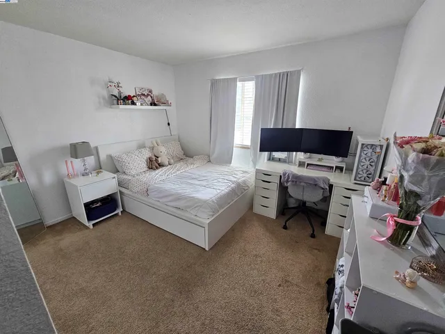 a bedroom with a bed and a couch