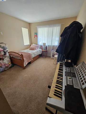 a bedroom with furniture and a window