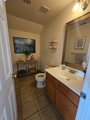 a bathroom with a sink toilet and mirror