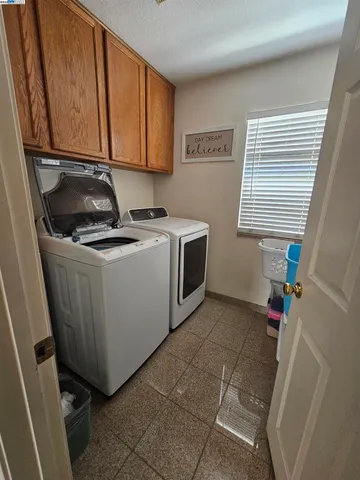 a utility room with a sink a washer and dryer