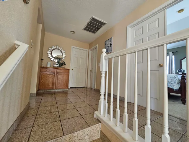 a view of wooden floor and chair in a kitchen