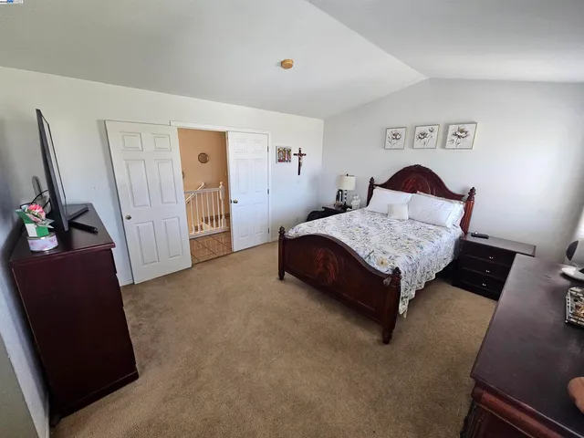 a spacious bedroom with a bed and furniture