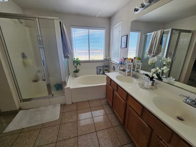 a bathroom with a tub sink and mirror