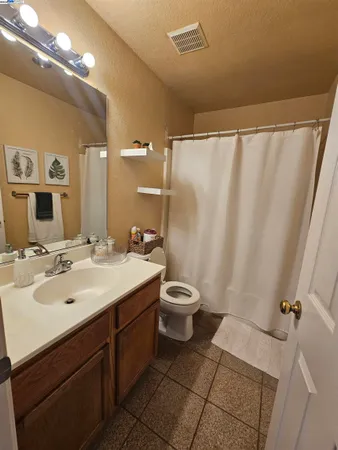 a bathroom with a sink and mirror with toilet