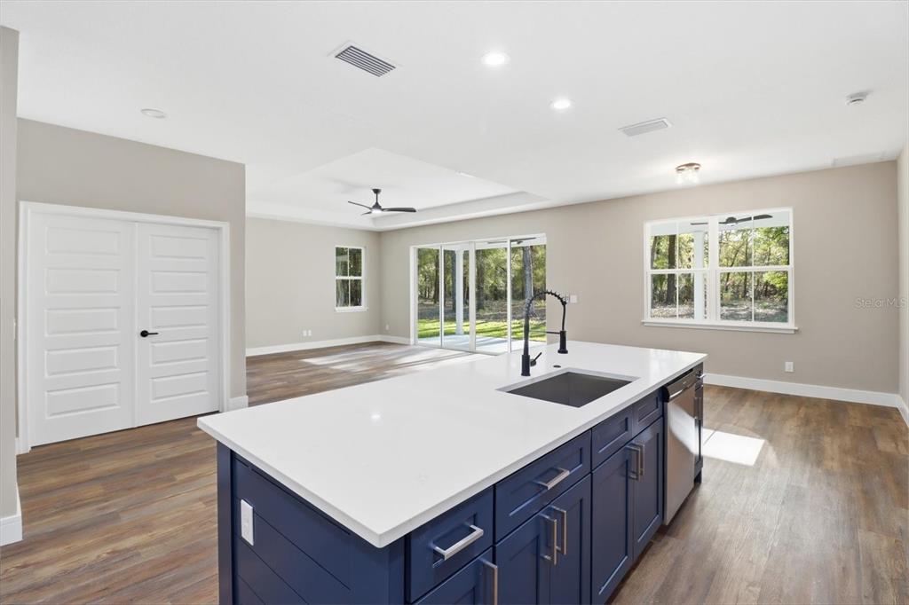 19126 Southwest 101st Street Dunnellon, FL 34432 - Photo 12 of 46 a kitchen with sink cabinets and wooden floor