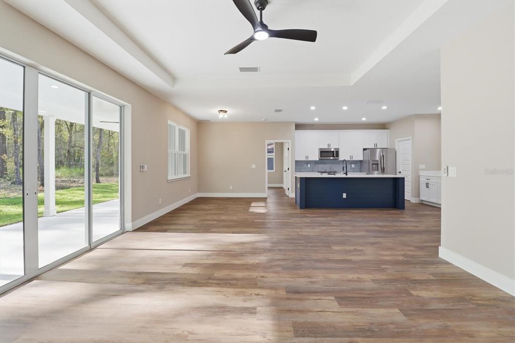 19126 Southwest 101st Street Dunnellon, FL 34432 - Photo 16 of 46 a view of kitchen and kitchen with furniture wooden floor and window