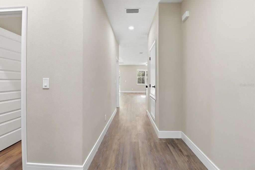 19126 Southwest 101st Street Dunnellon, FL 34432 - Photo 6 of 46 a view of a hallway with wooden floor