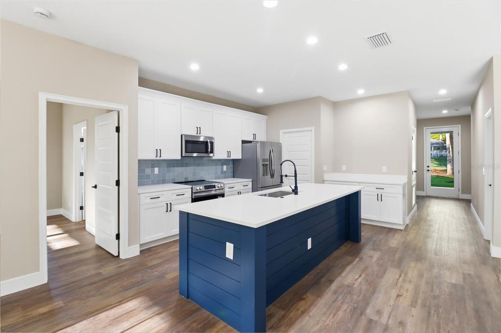 19126 Southwest 101st Street Dunnellon, FL 34432 - Photo 8 of 46 a kitchen with a sink and wooden floor
