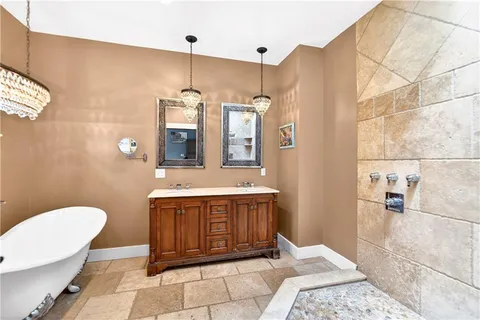 a bathroom with a sink a mirror a toilet and bathtub