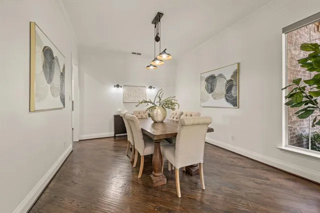 a view of a dining room with furniture wooden floor and a chandelier