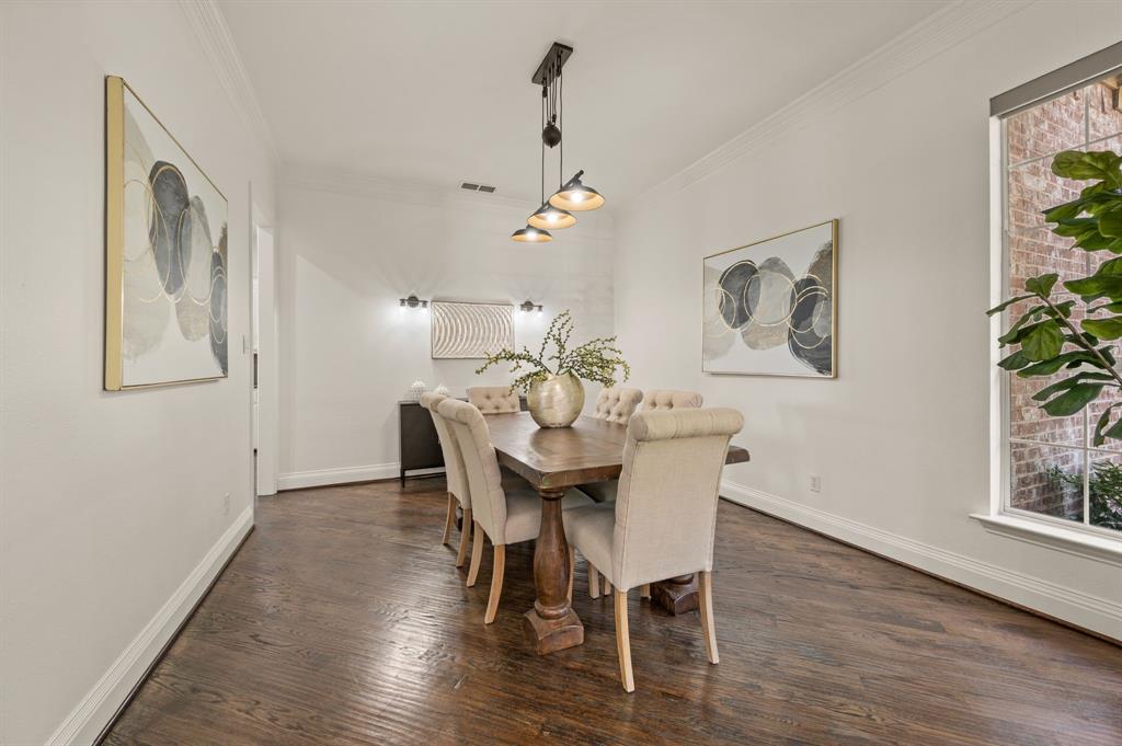 2038 Azalea Trail Irving, TX 75063 - Photo 11 of 39 a view of a dining room with furniture wooden floor and a chandelier