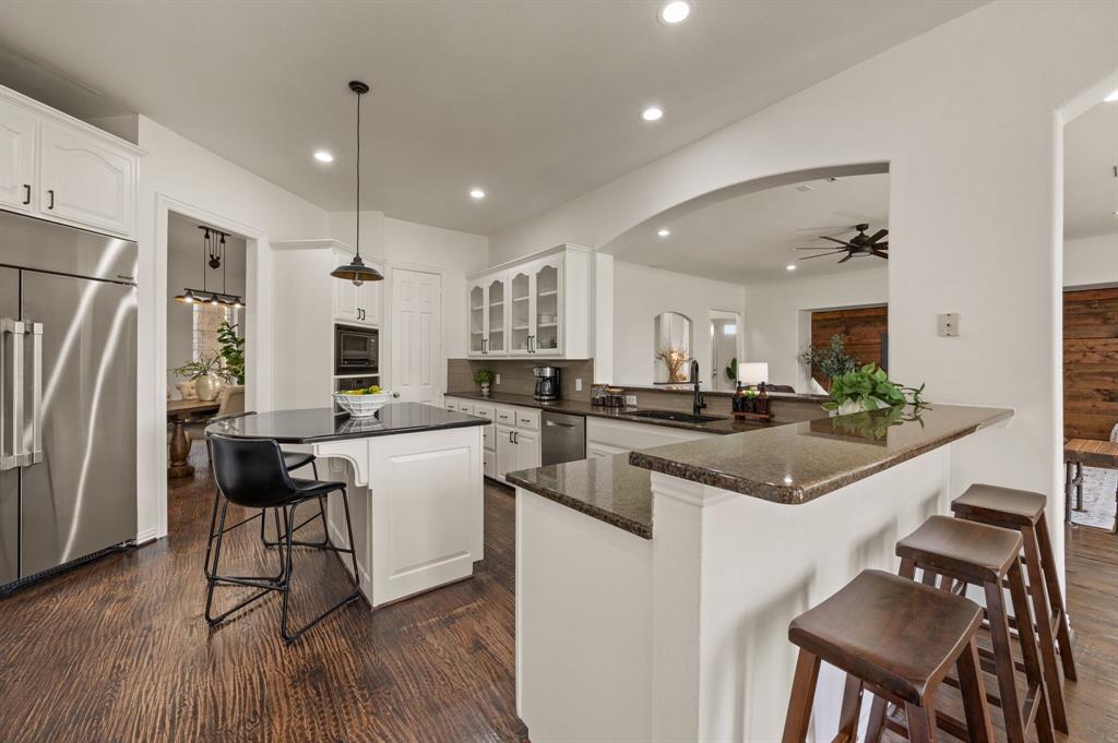 2038 Azalea Trail Irving, TX 75063 - Photo 18 of 39 a kitchen with a sink a counter top space stainless steel appliances and cabinets