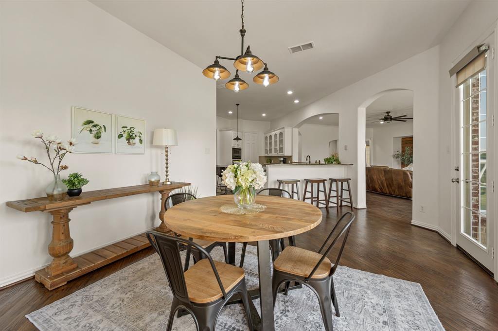 2038 Azalea Trail Irving, TX 75063 - Photo 20 of 39 a view of a dining room with furniture and wooden floor