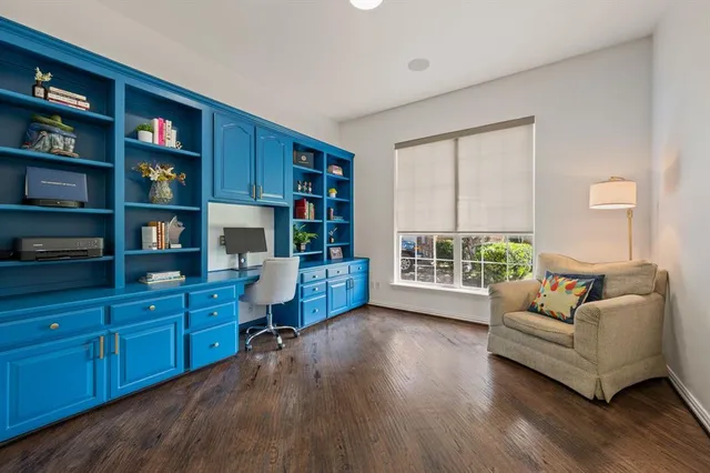 a living room with furniture and a book shelf