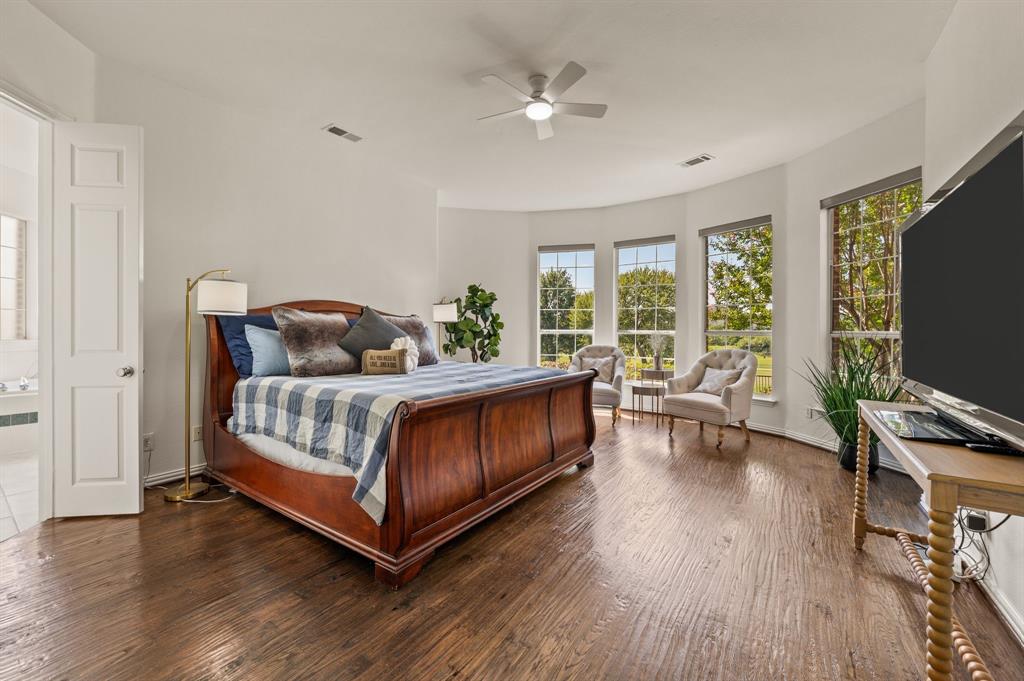 2038 Azalea Trail Irving, TX 75063 - Photo 23 of 39 a bedroom with a bed and a flat screen tv