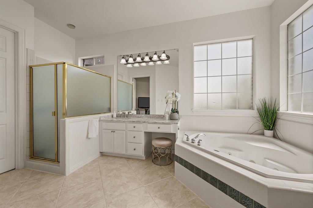 2038 Azalea Trail Irving, TX 75063 - Photo 24 of 39 a bathroom with a tub a sink and a large mirror