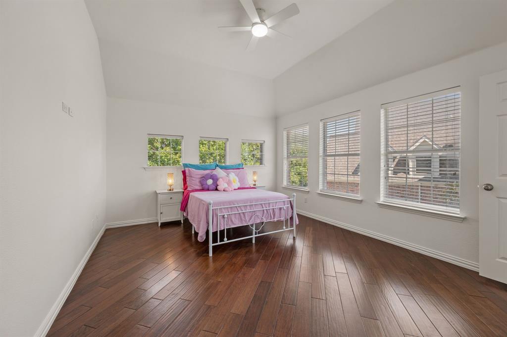 2038 Azalea Trail Irving, TX 75063 - Photo 28 of 39 a bedroom with a bed and wooden floor