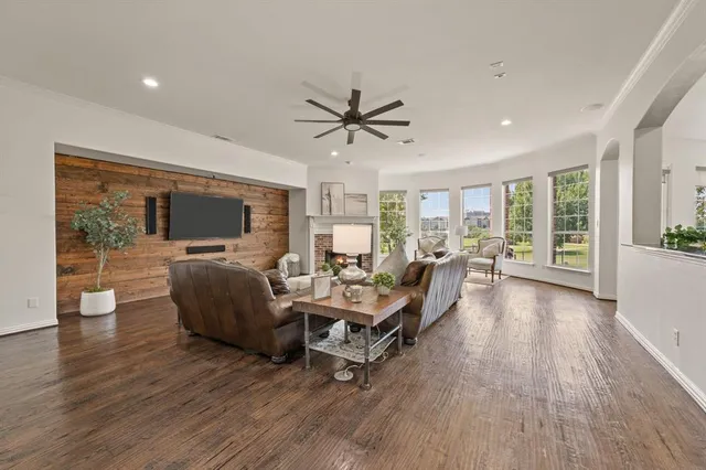 a living room with furniture flat screen tv and wooden floor
