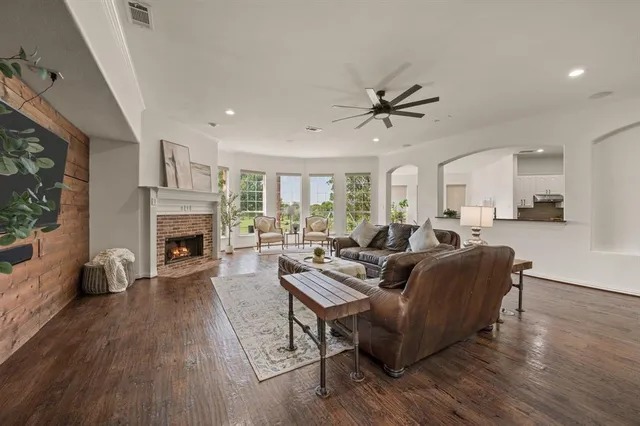 a living room with furniture a fireplace and a flat screen tv