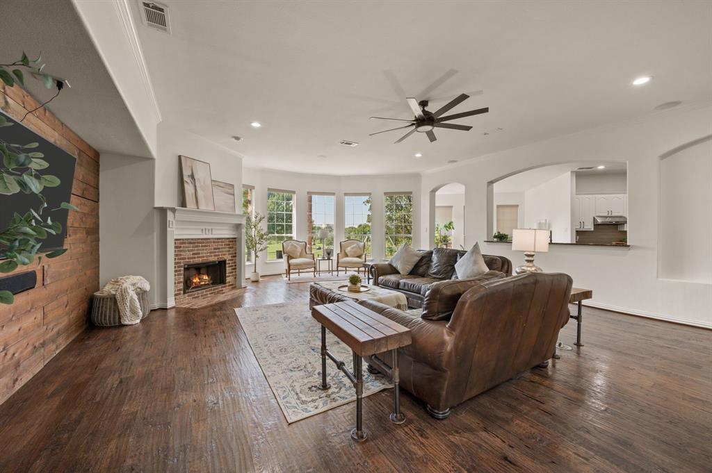 2038 Azalea Trail Irving, TX 75063 - Photo 9 of 39 a living room with furniture a fireplace and a flat screen tv
