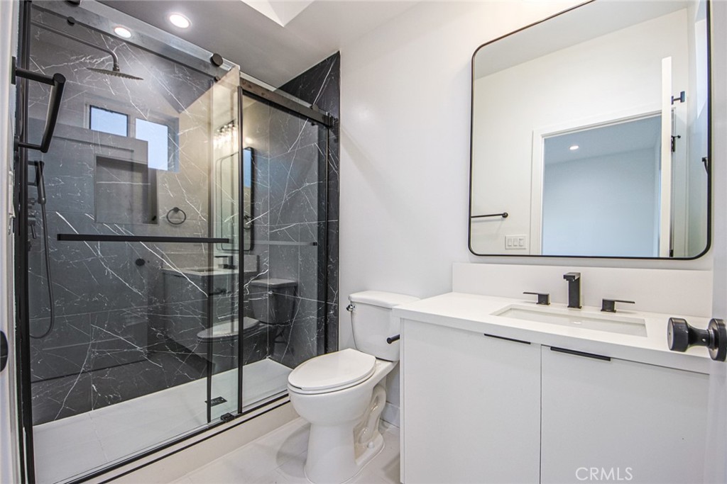 2202 Thurman Avenue Los Angeles, CA 90016 - Photo 11 of 25 a bathroom with a toilet a sink and shower