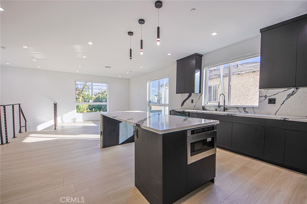2202 Thurman Avenue Los Angeles, CA 90016 - Photo 13 of 25 a kitchen with stainless steel appliances granite countertop a sink and a stove