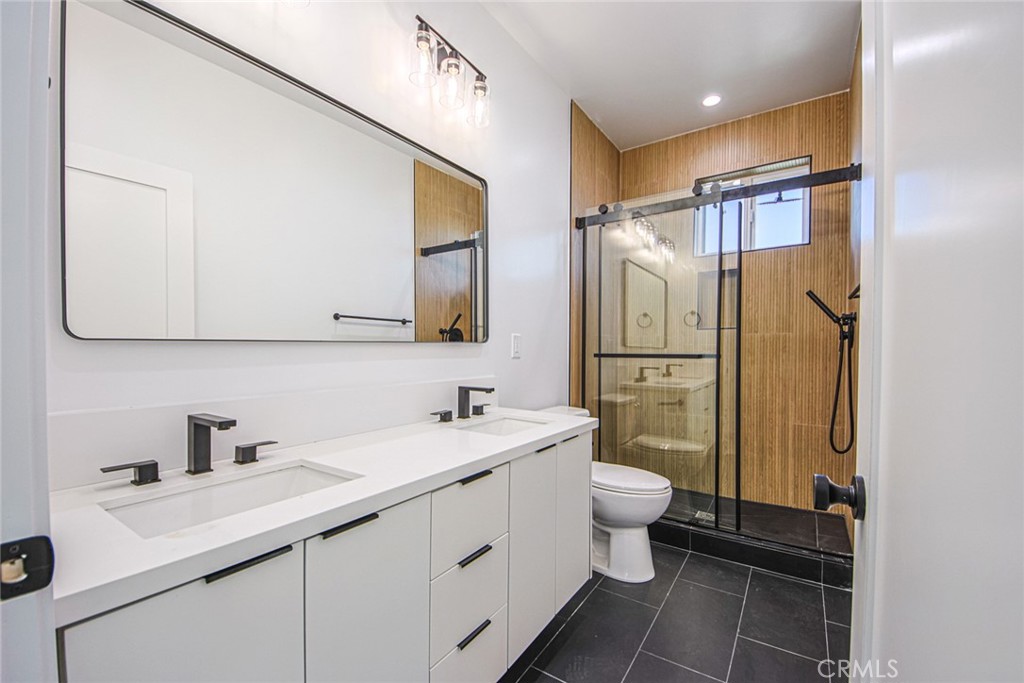 2202 Thurman Avenue Los Angeles, CA 90016 - Photo 16 of 25 a bathroom with a double vanity sink mirror and toilet